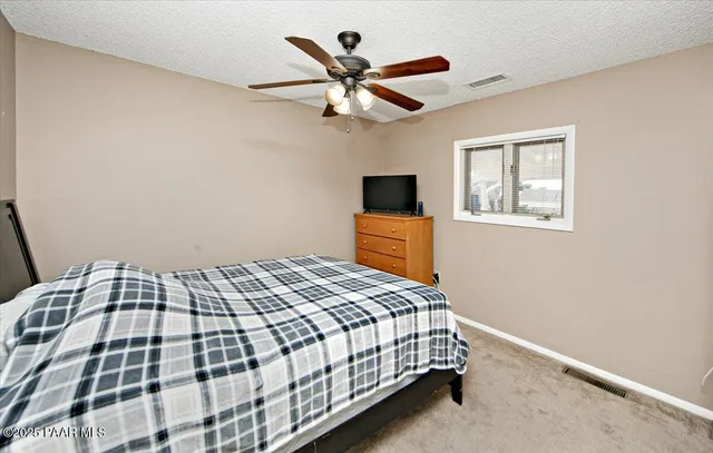 a bathroom with a sink vanity granite toilet and shower