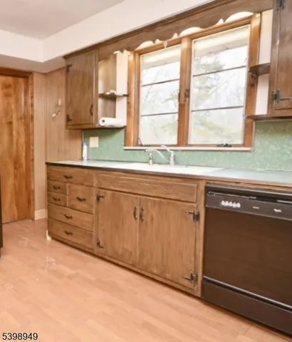 a kitchen with granite countertop white cabinets and a window