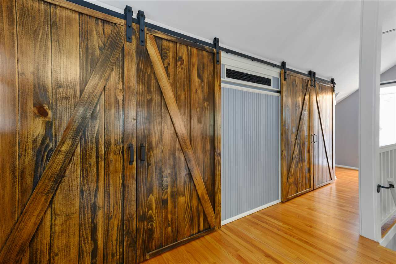 2618 Van Dyke Avenue Raleigh, NC 27607 - Photo 13 of 30 Beautiful wood sliding barn doors adorn the his/hers walk-in closets in the master bedroom. Walk-in Closet