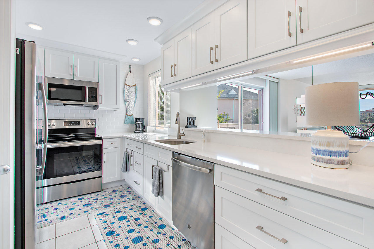 353 Highway 1, Unit B301 Jupiter, FL 33477 - Photo 11 of 58 a kitchen with granite countertop a sink stainless steel appliances and cabinets