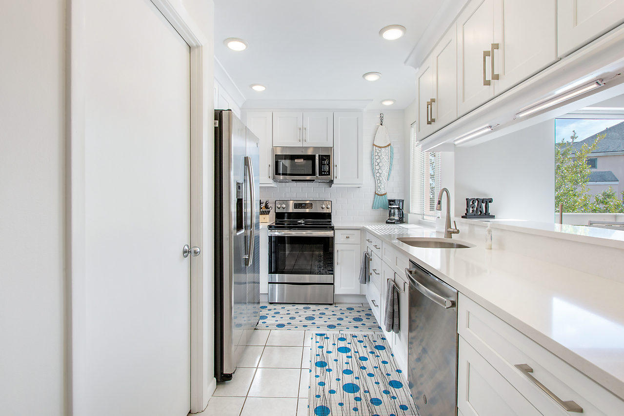 353 Highway 1, Unit B301 Jupiter, FL 33477 - Photo 12 of 58 a kitchen with granite countertop a refrigerator and a sink