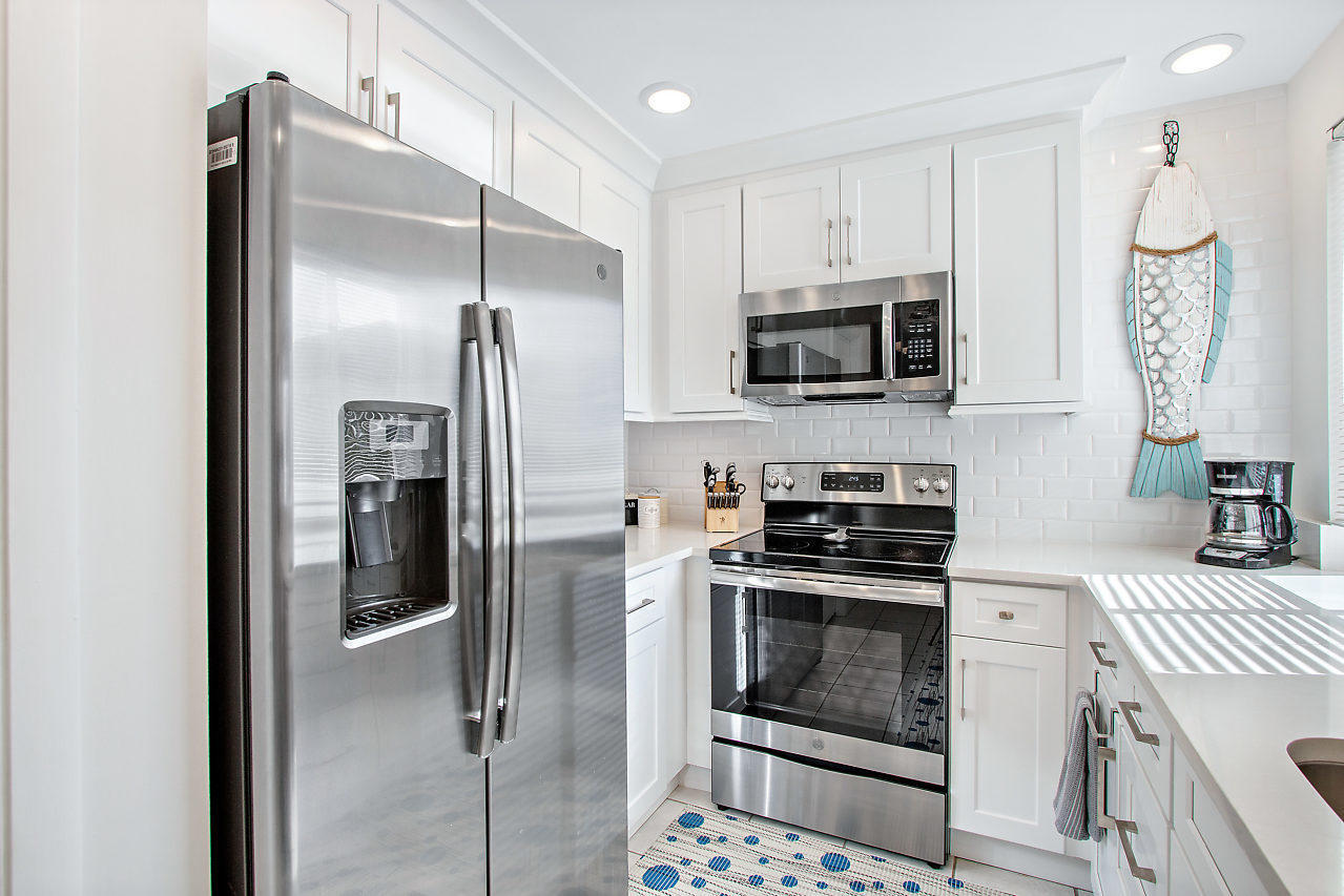 353 Highway 1, Unit B301 Jupiter, FL 33477 - Photo 13 of 58 a kitchen with a stove microwave and refrigerator