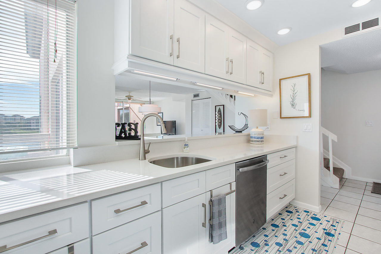 353 Highway 1, Unit B301 Jupiter, FL 33477 - Photo 14 of 58 a kitchen with a sink and cabinets