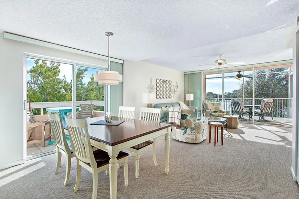 a living room with furniture a flat screen tv and a large window