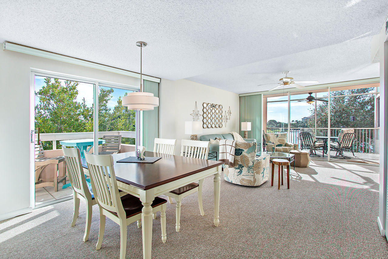 353 Highway 1, Unit B301 Jupiter, FL 33477 - Photo 15 of 58 a dining room with furniture large windows and a chandelier