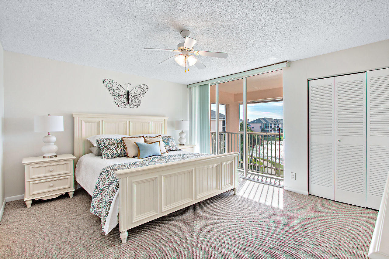 353 Highway 1, Unit B301 Jupiter, FL 33477 - Photo 21 of 58 a bedroom with a balcony a bed and a chandelier