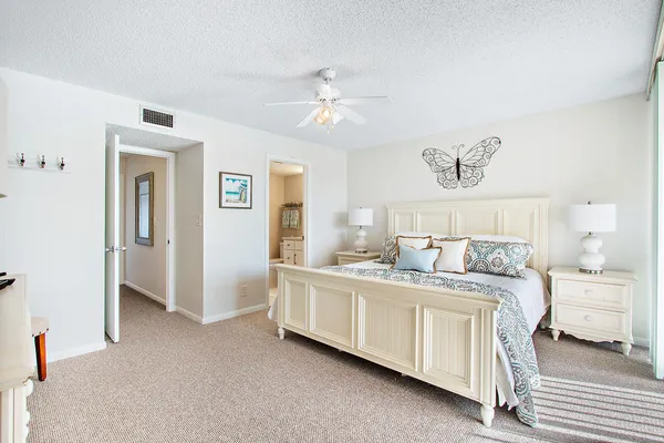 a bedroom with two beds and a chandelier
