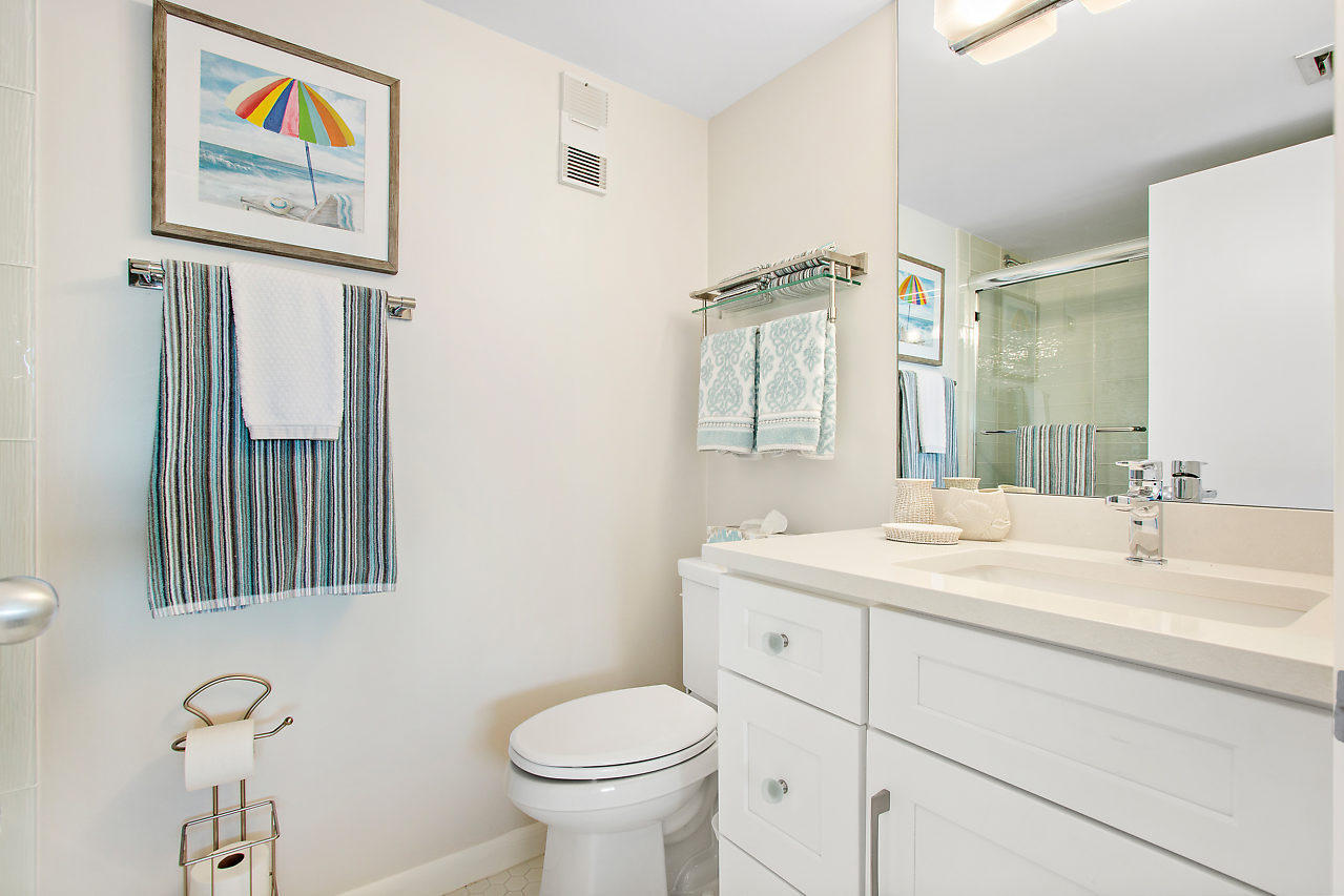 353 Highway 1, Unit B301 Jupiter, FL 33477 - Photo 23 of 58 a bathroom with a sink a toilet and mirror