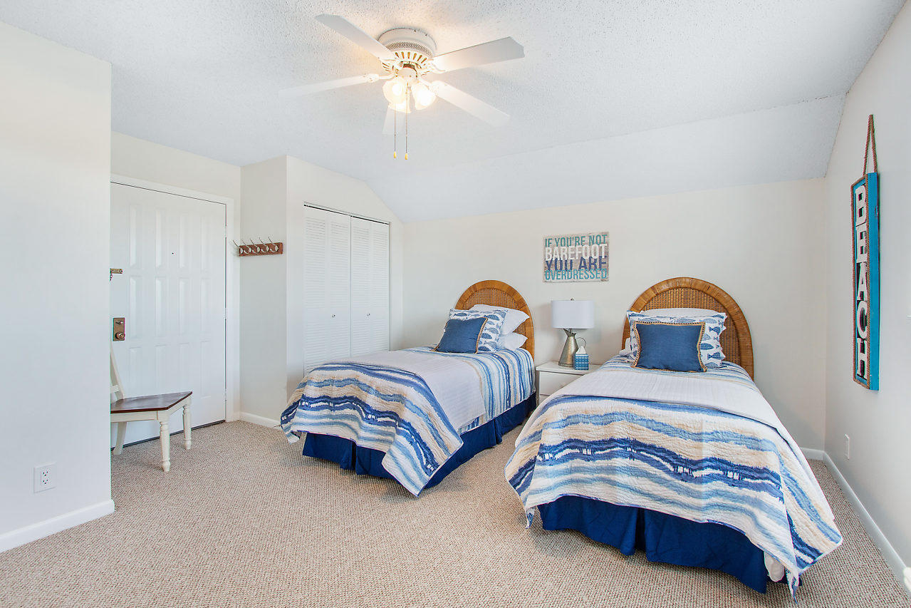 353 Highway 1, Unit B301 Jupiter, FL 33477 - Photo 25 of 58 a bedroom with two beds and a chandelier