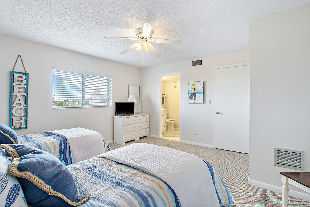 353 Highway 1, Unit B301 Jupiter, FL 33477 - Photo 26 of 58 a bedroom with two beds and a chandelier