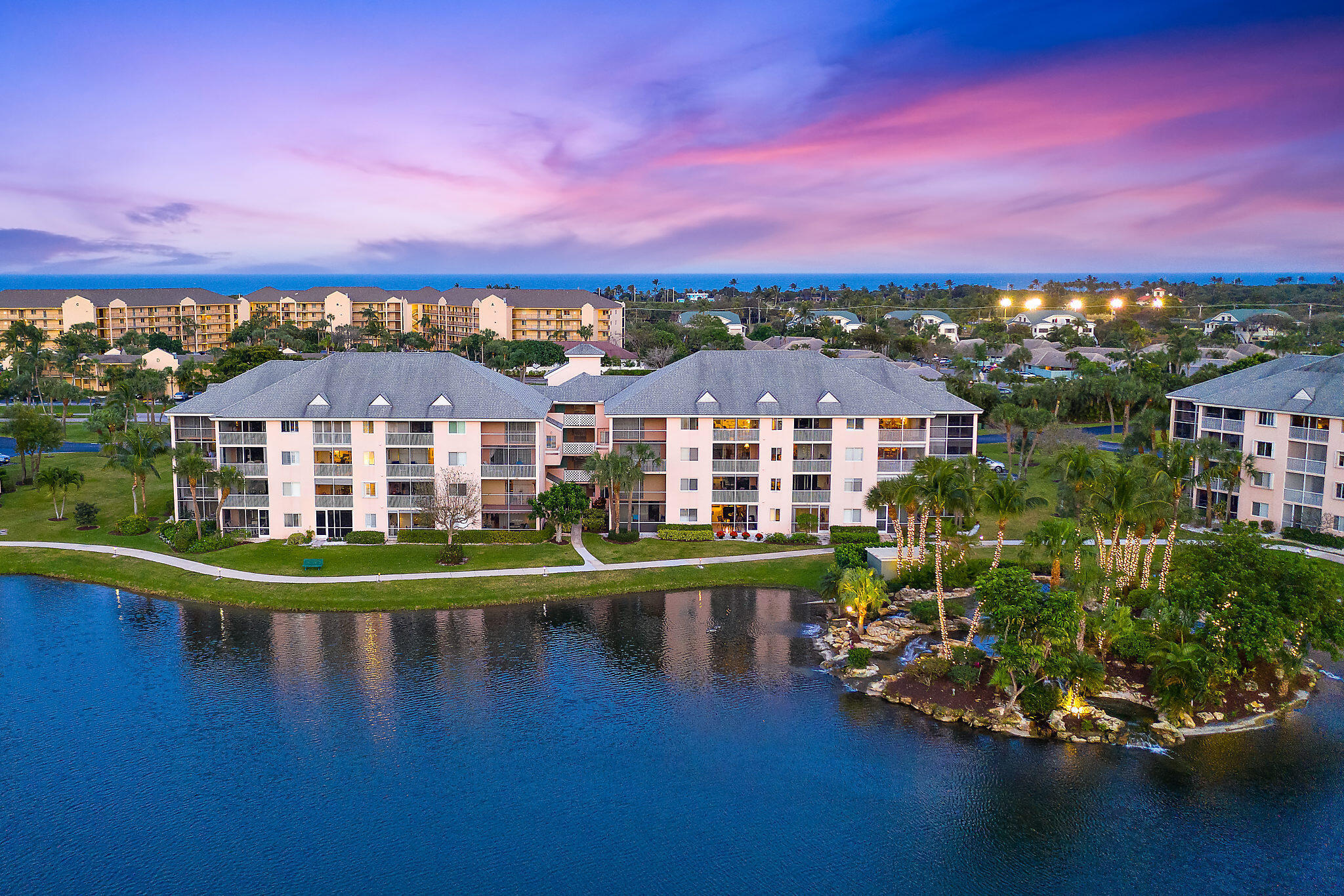 353 Highway 1, Unit B301 Jupiter, FL 33477 - Photo 41 of 58 a view of a lake with a houses in the background