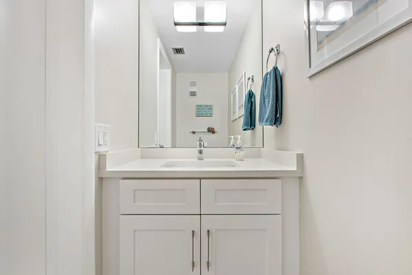 a kitchen with granite countertop a refrigerator and a sink