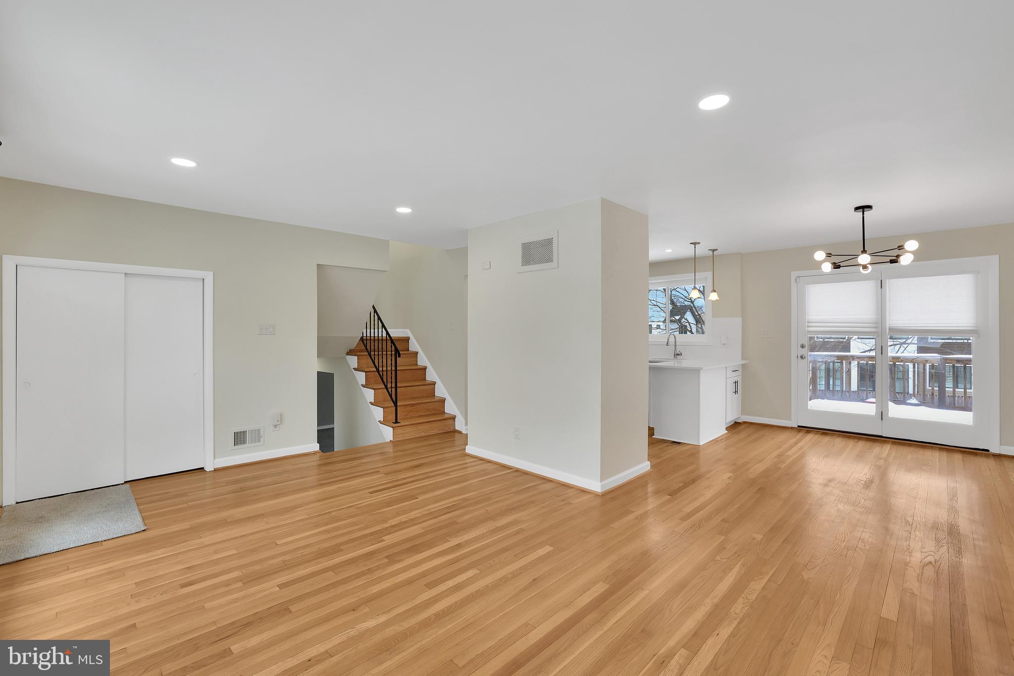 6718 Old Chesterbrook Road McLean, VA 22101 - Photo 12 of 49 a view of a big room with wooden floor and a kitchen