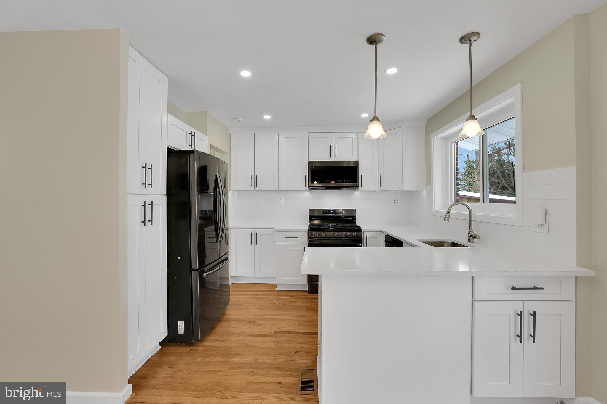 6718 Old Chesterbrook Road McLean, VA 22101 - Photo 18 of 49 a kitchen with stainless steel appliances a refrigerator sink and microwave