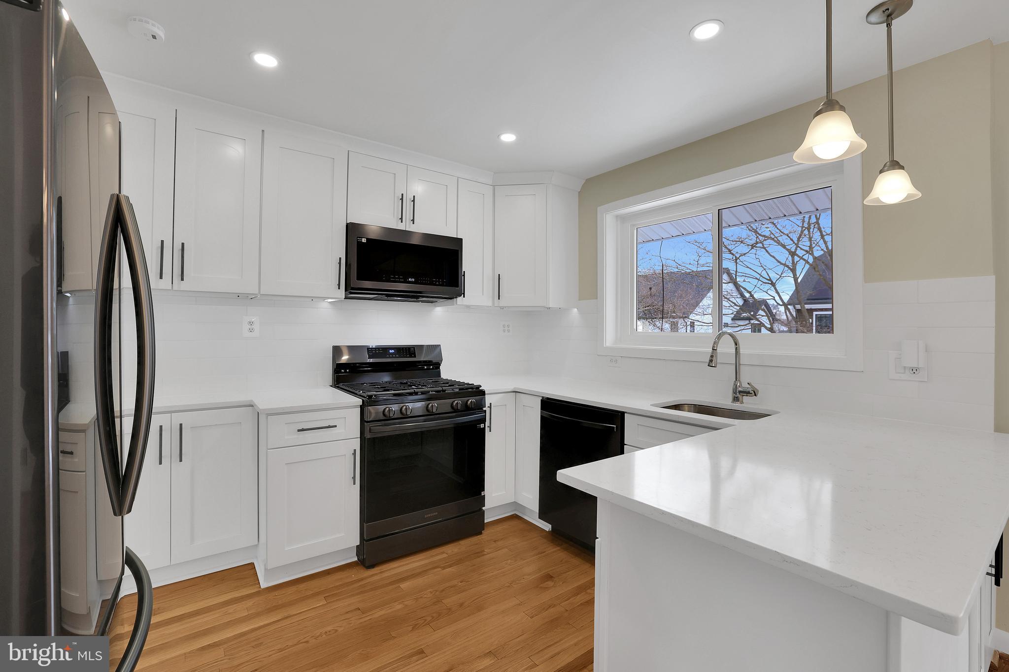 6718 Old Chesterbrook Road McLean, VA 22101 - Photo 19 of 49 a kitchen with stainless steel appliances granite countertop a sink stove and refrigerator