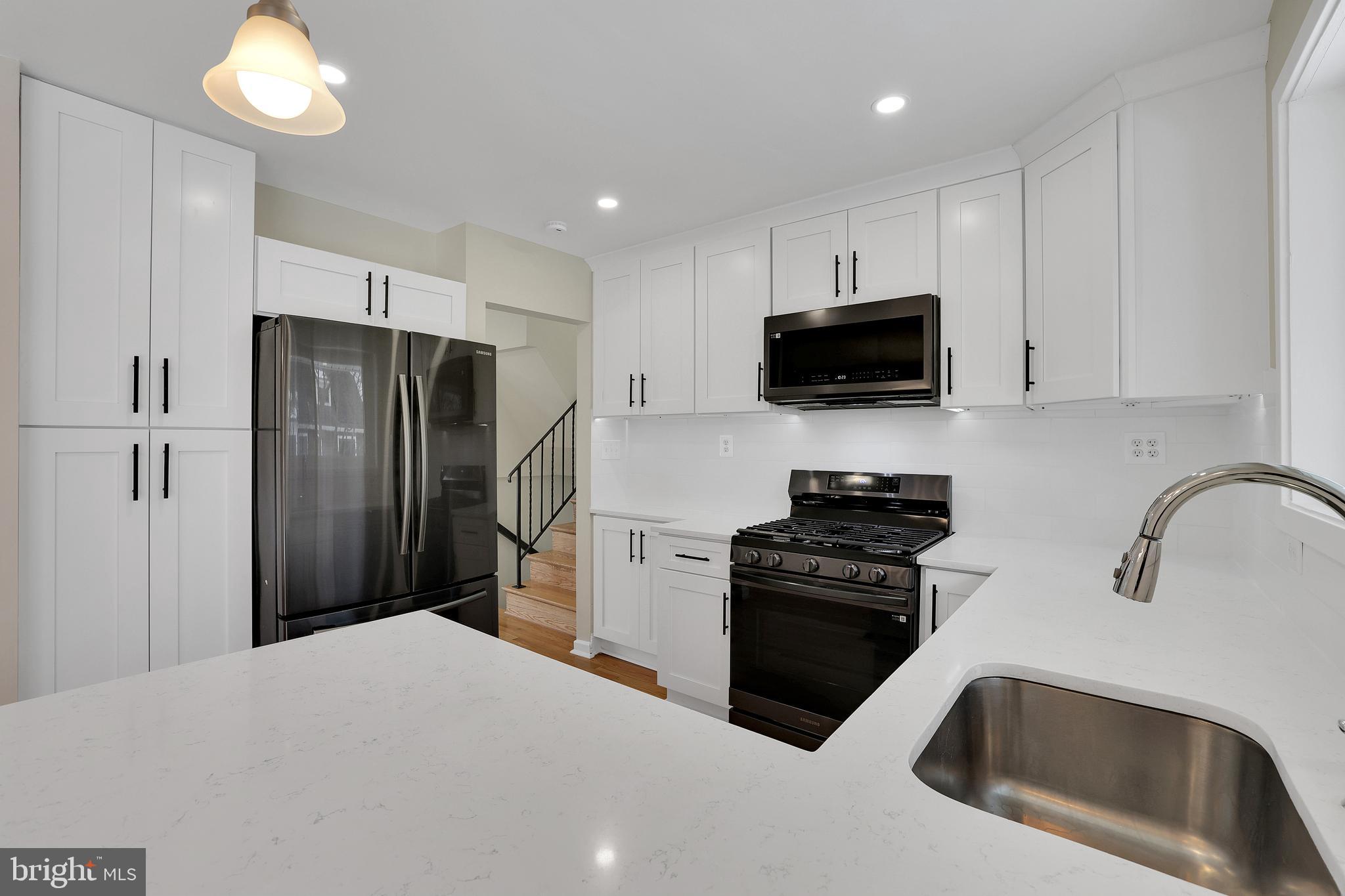6718 Old Chesterbrook Road McLean, VA 22101 - Photo 20 of 49 a kitchen with a refrigerator a stove and a sink
