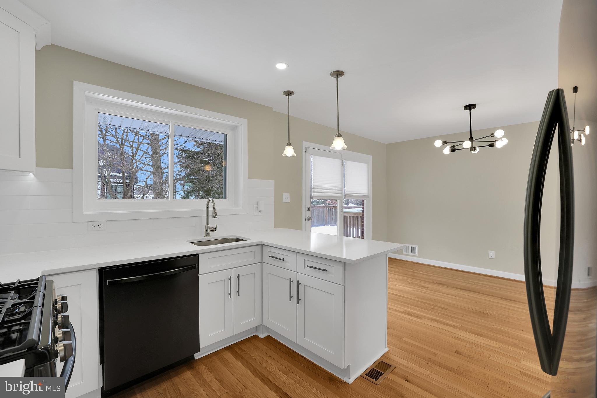 6718 Old Chesterbrook Road McLean, VA 22101 - Photo 21 of 49 a open kitchen with a sink a window and wooden floor
