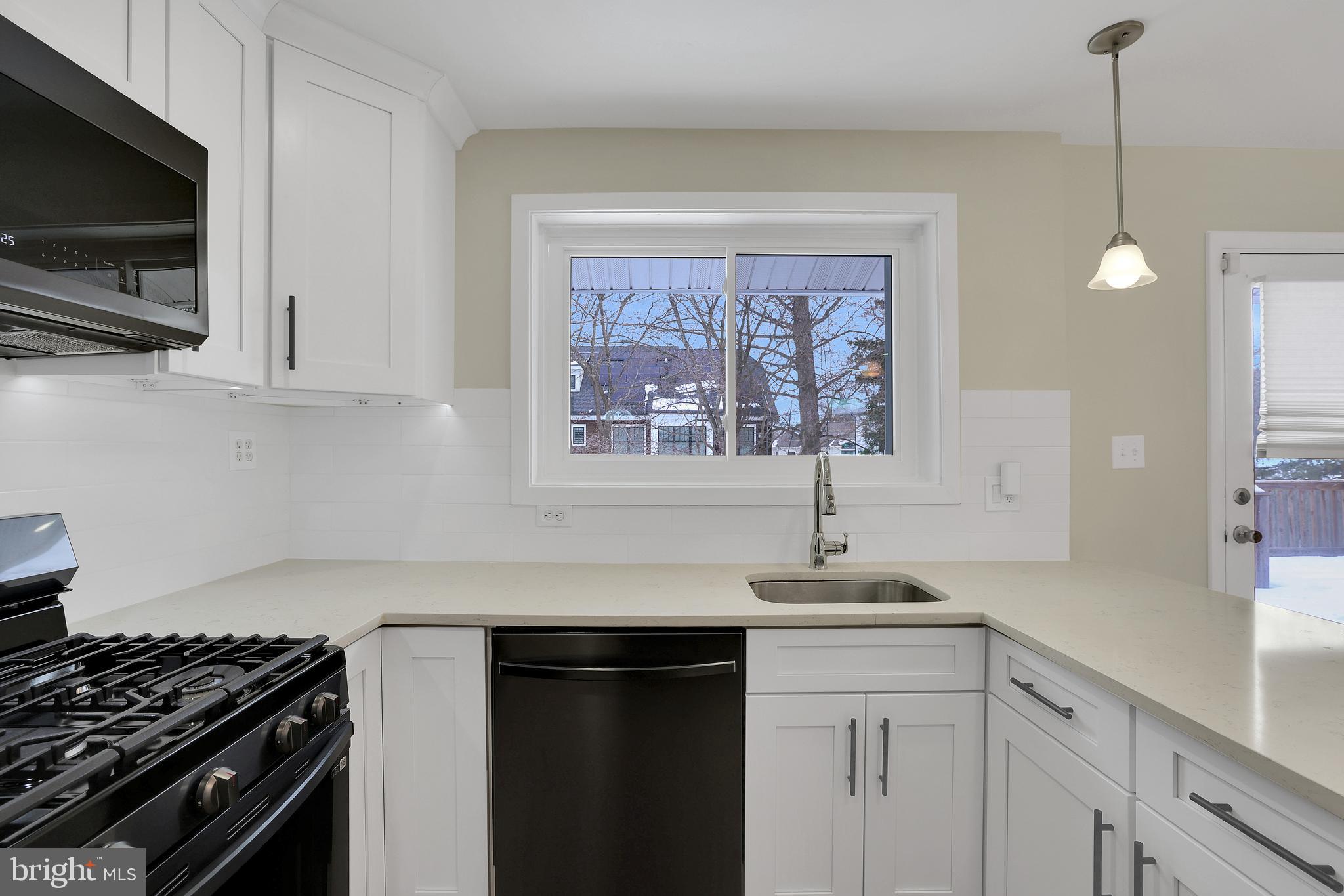 6718 Old Chesterbrook Road McLean, VA 22101 - Photo 24 of 49 a kitchen with stainless steel appliances a sink stove and microwave