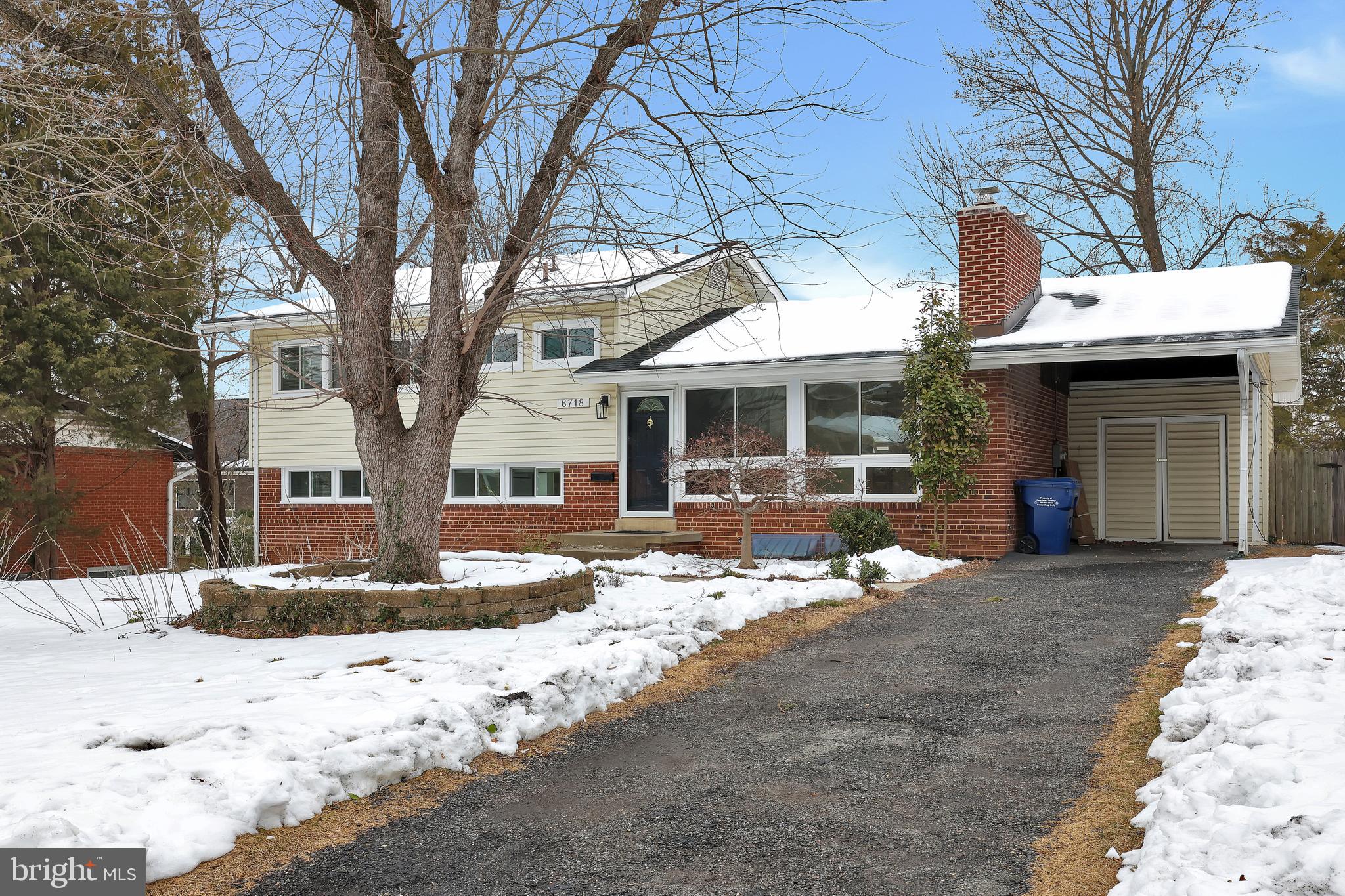 6718 Old Chesterbrook Road McLean, VA 22101 - Photo 43 of 49 a front view of a house with a yard covered with snow and trees