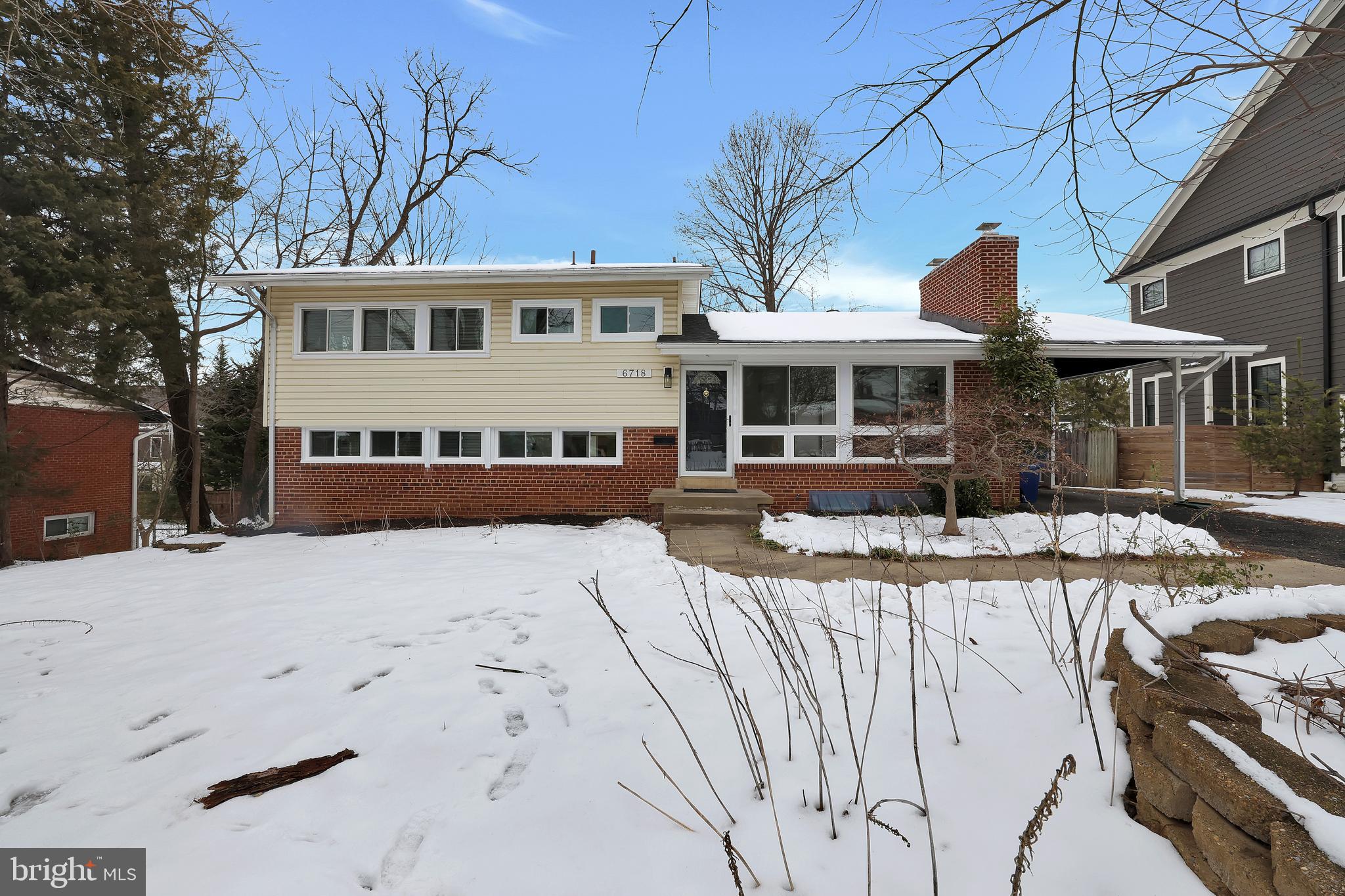 6718 Old Chesterbrook Road McLean, VA 22101 - Photo 44 of 49 a front view of a house with a snow in the yard