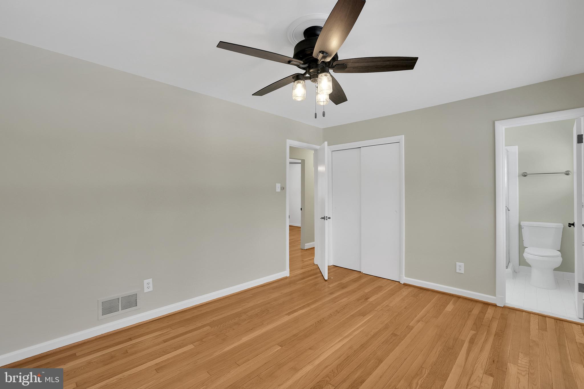 6718 Old Chesterbrook Road McLean, VA 22101 - Photo 5 of 49 a view of a room with a wooden floor and a ceiling fan