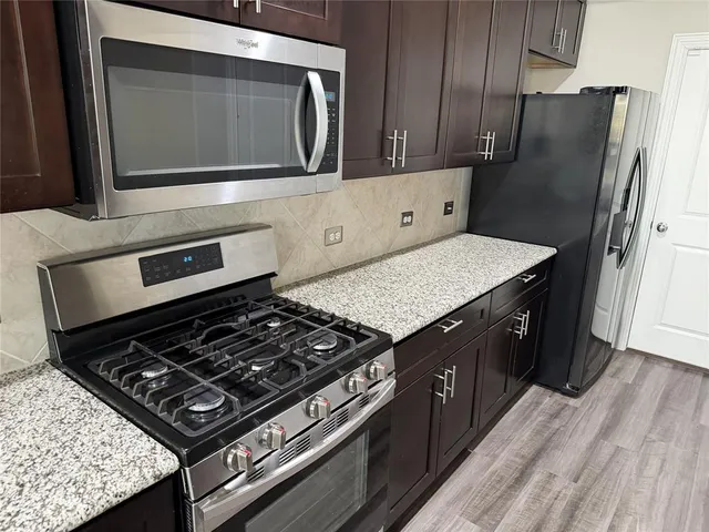 a kitchen with wooden cabinets and a stove top oven