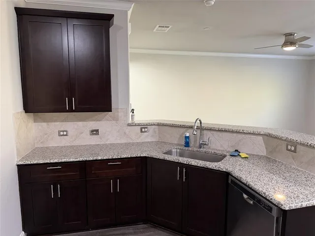 a kitchen with granite countertop cabinets sink and window