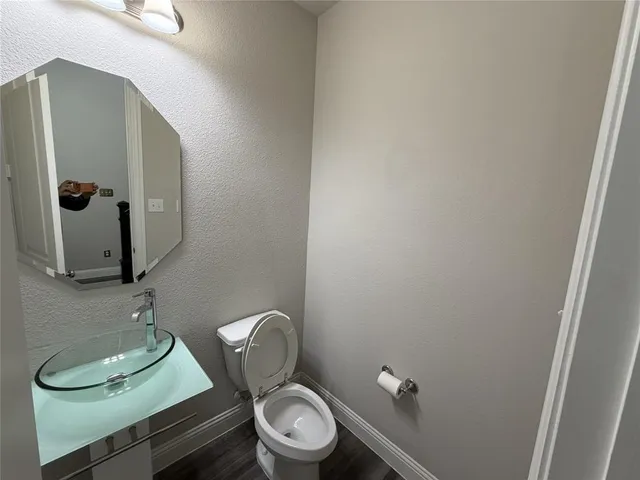 a bathroom with a toilet and a mirror
