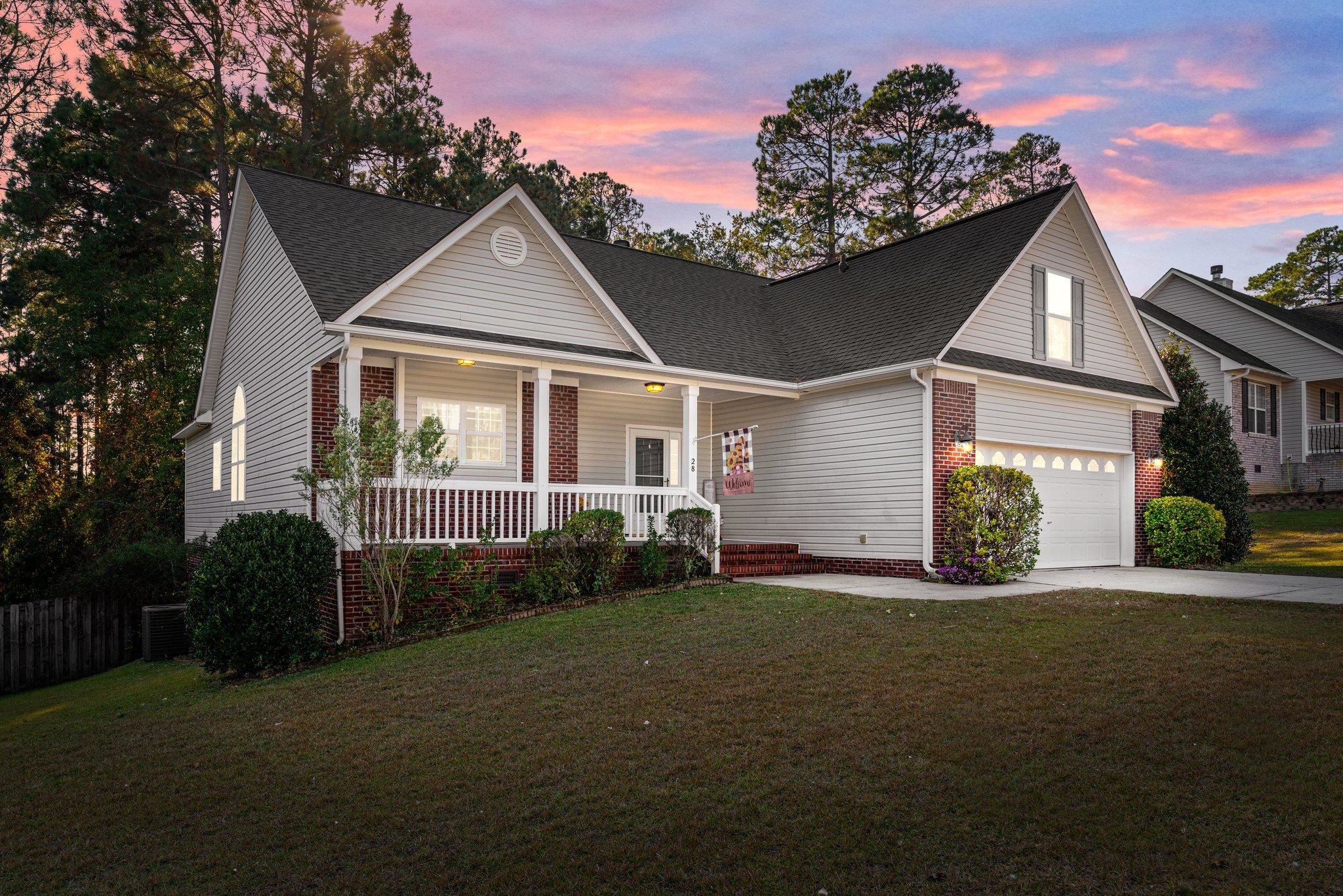 28 Commonwealth Court Cameron, NC 28326 - Photo 1 of 39 a front view of a house with a garden