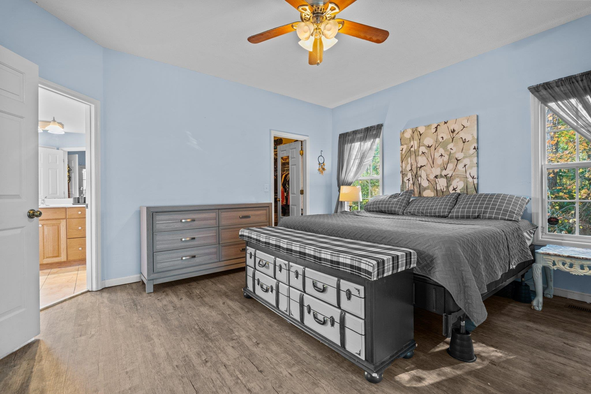 28 Commonwealth Court Cameron, NC 28326 - Photo 16 of 39 a spacious bedroom with a bed and a chandelier
