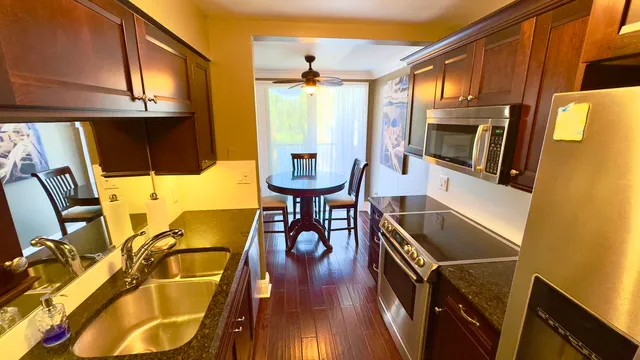 a view of a lake with a table and chairs