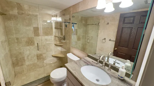 a view of a hallway with wooden floor and a living room