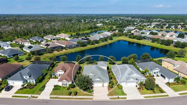 an aerial view of a house with a garden and lake view