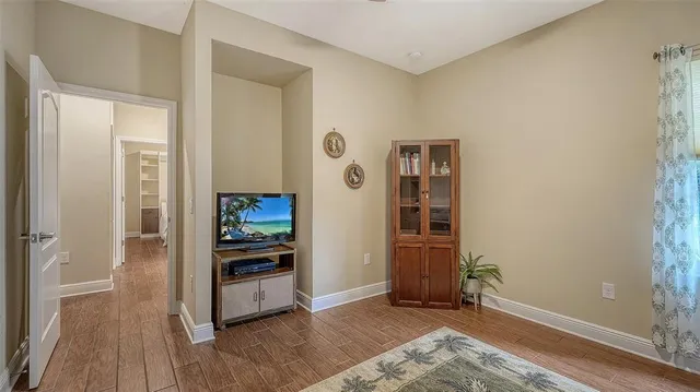 a bathroom with a granite countertop sink a toilet a mirror and shower curtain