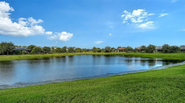 a view of a house with swimming pool and sitting area