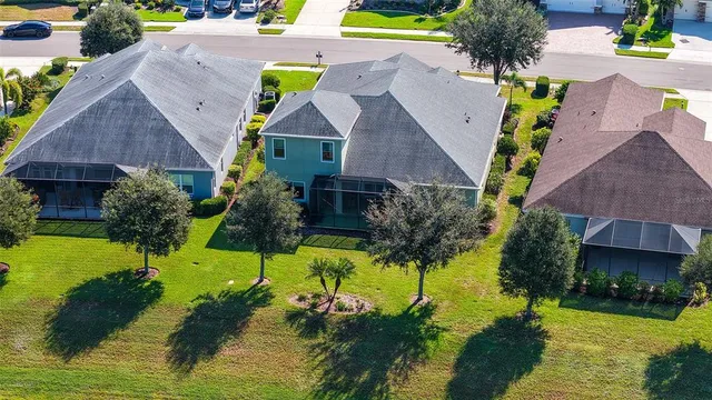 a view of a swimming pool with a yard and plants