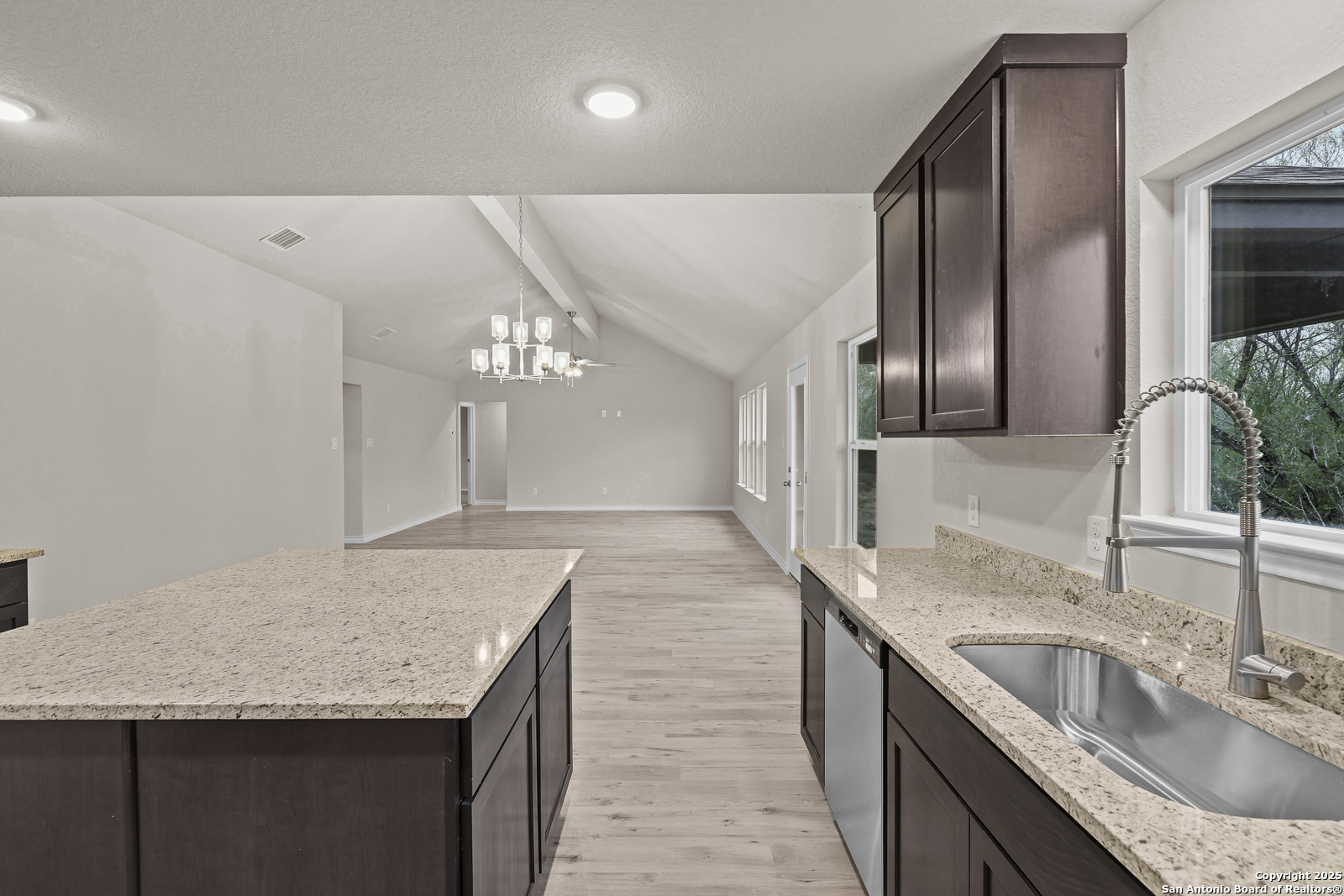 149 Sylas Hayes Loop Pleasanton, TX 78064 - Photo 14 of 38 a kitchen with stainless steel appliances granite countertop a sink refrigerator and cabinets