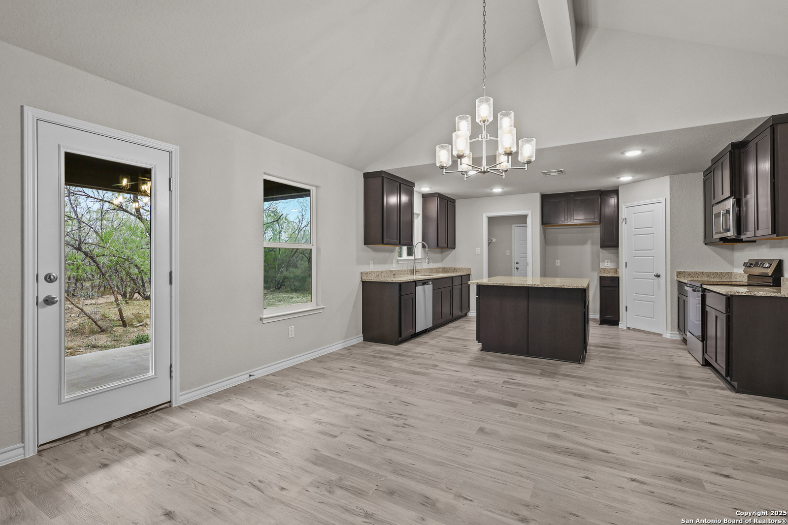 149 Sylas Hayes Loop Pleasanton, TX 78064 - Photo 16 of 38 a large white kitchen with a large window