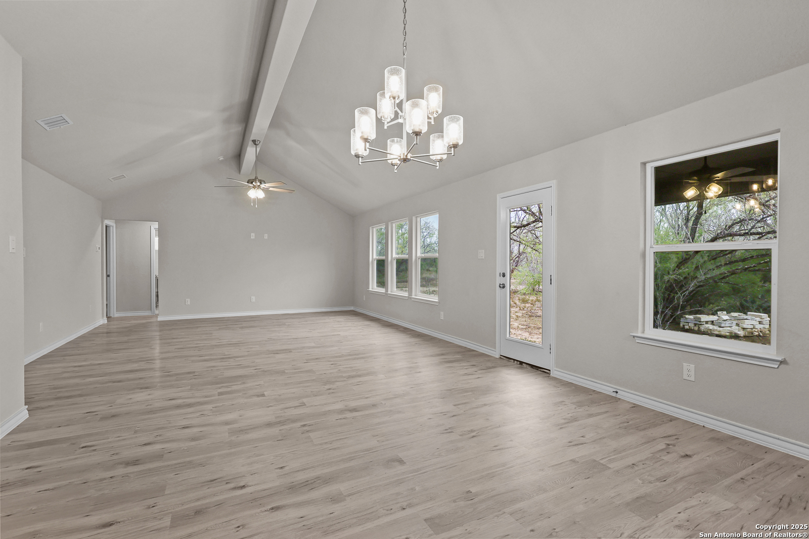 149 Sylas Hayes Loop Pleasanton, TX 78064 - Photo 17 of 38 a view of an empty room with wooden floor and a window
