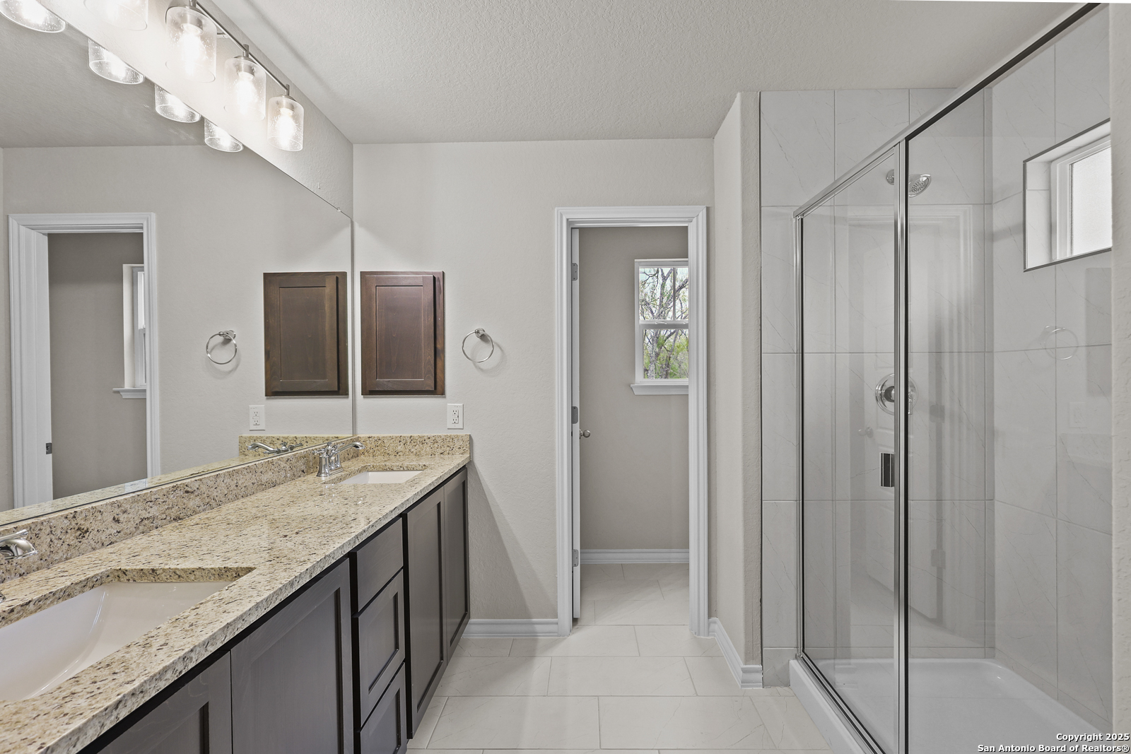 149 Sylas Hayes Loop Pleasanton, TX 78064 - Photo 20 of 38 a bathroom with a granite countertop sink and a mirror