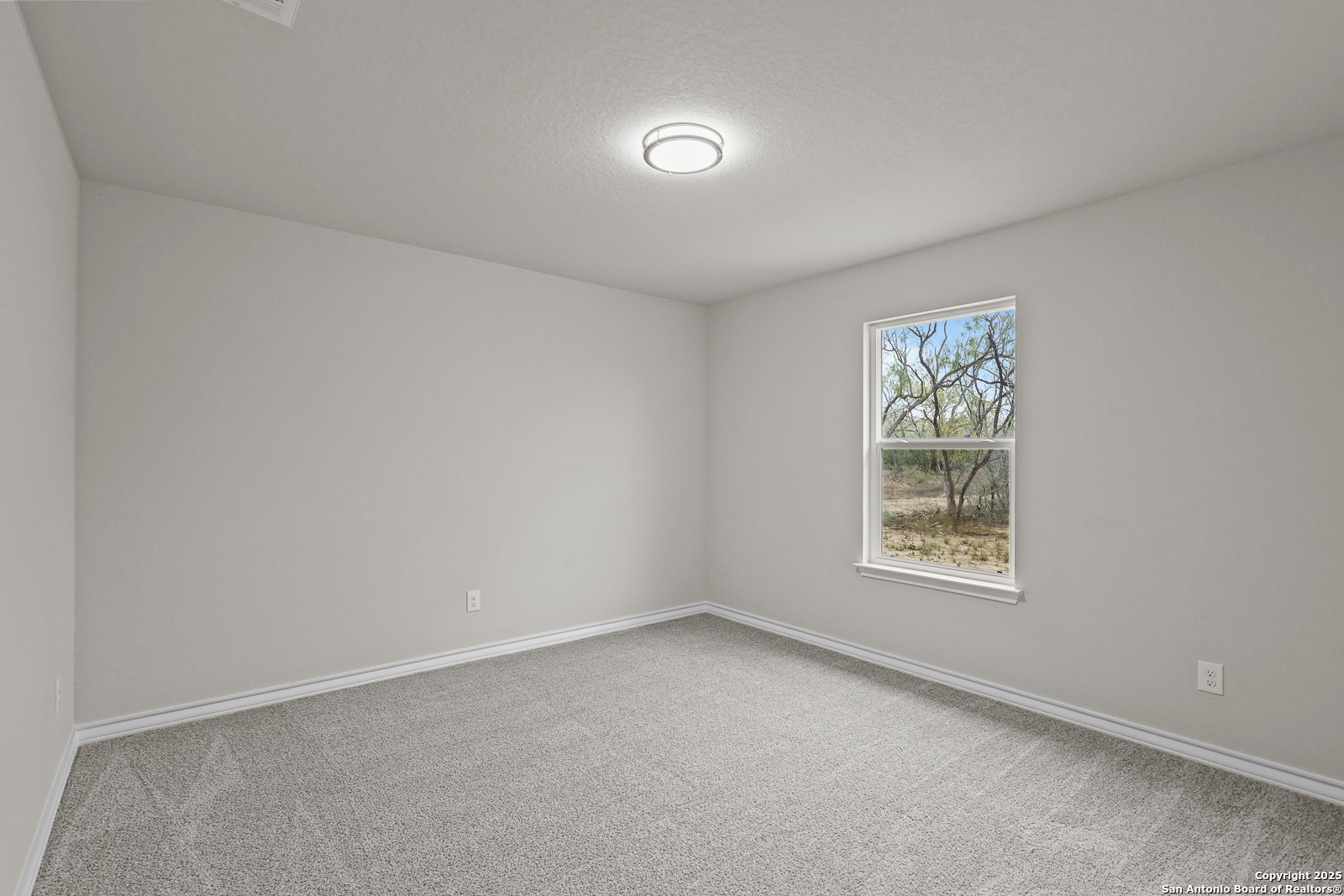 149 Sylas Hayes Loop Pleasanton, TX 78064 - Photo 26 of 38 an empty room with a window