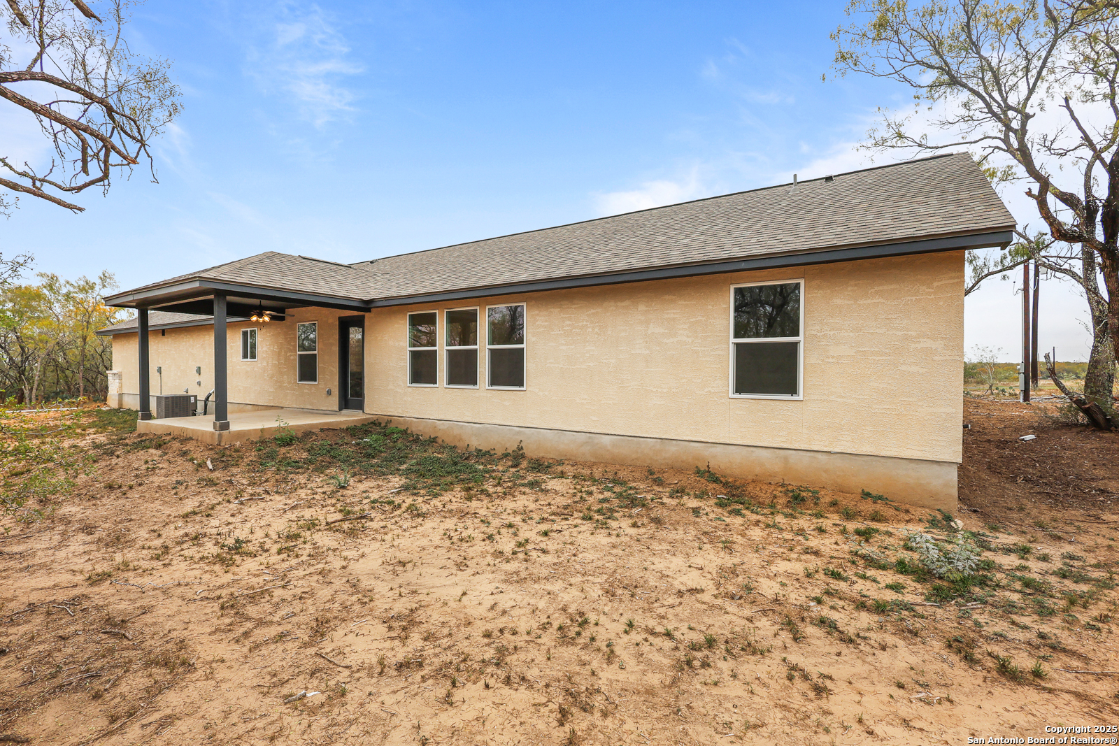 149 Sylas Hayes Loop Pleasanton, TX 78064 - Photo 29 of 38 a front view of a house with a yard