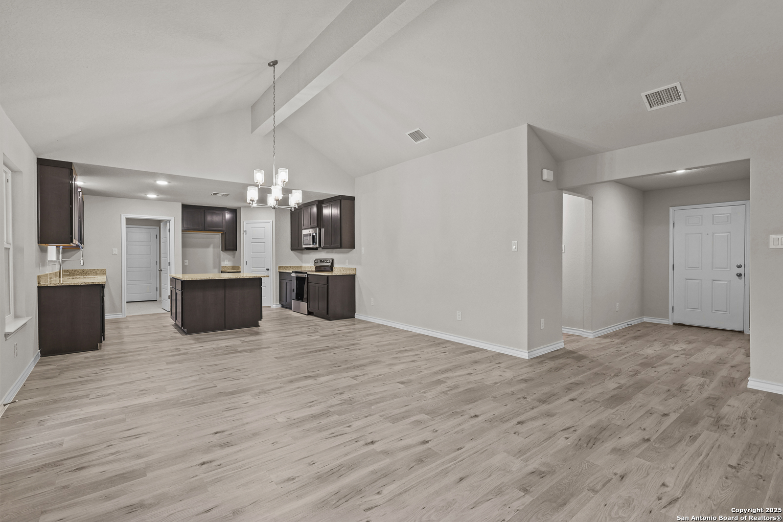 149 Sylas Hayes Loop Pleasanton, TX 78064 - Photo 8 of 38 a view of a kitchen with a sink and a refrigerator