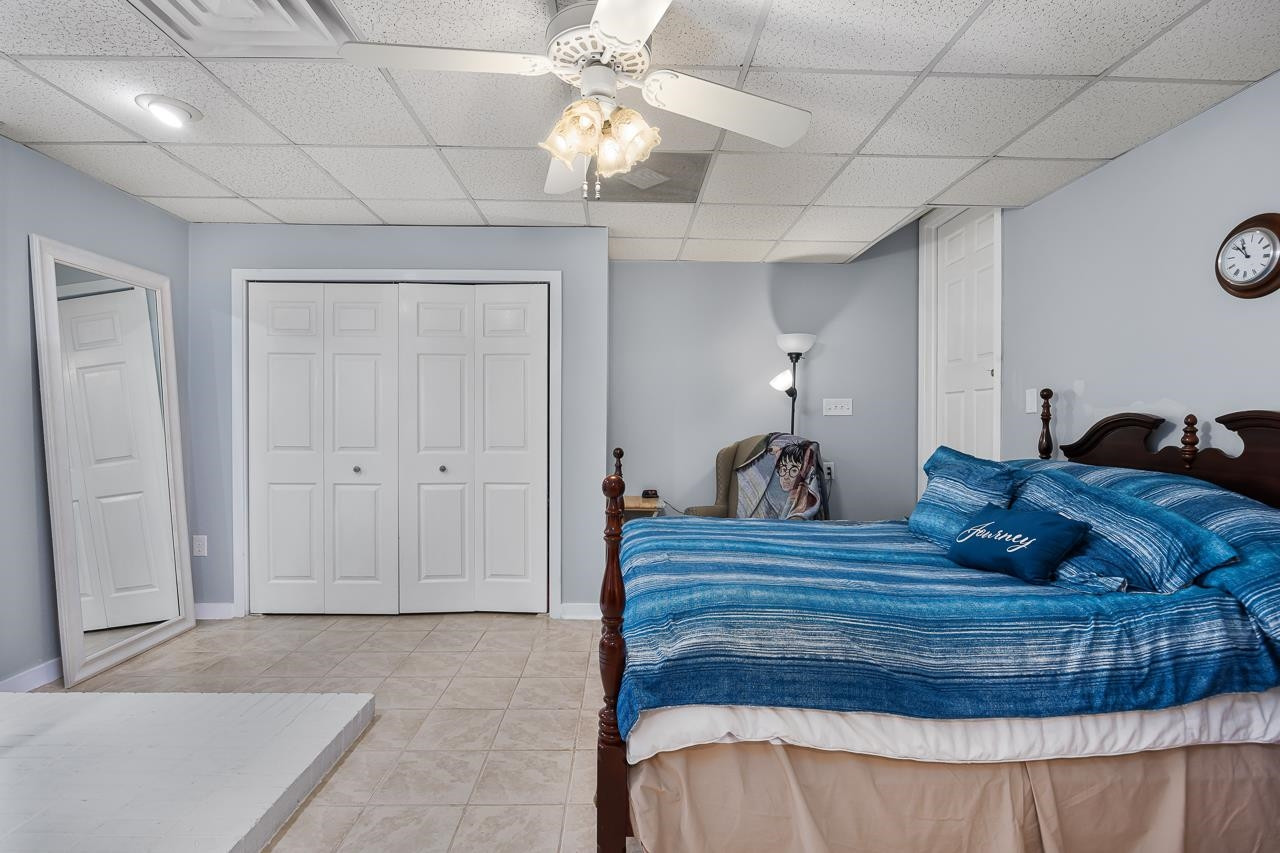 6345 Wynbrook Way Raleigh, NC 27612 - Photo 31 of 40 a bedroom with a bed and a chandelier