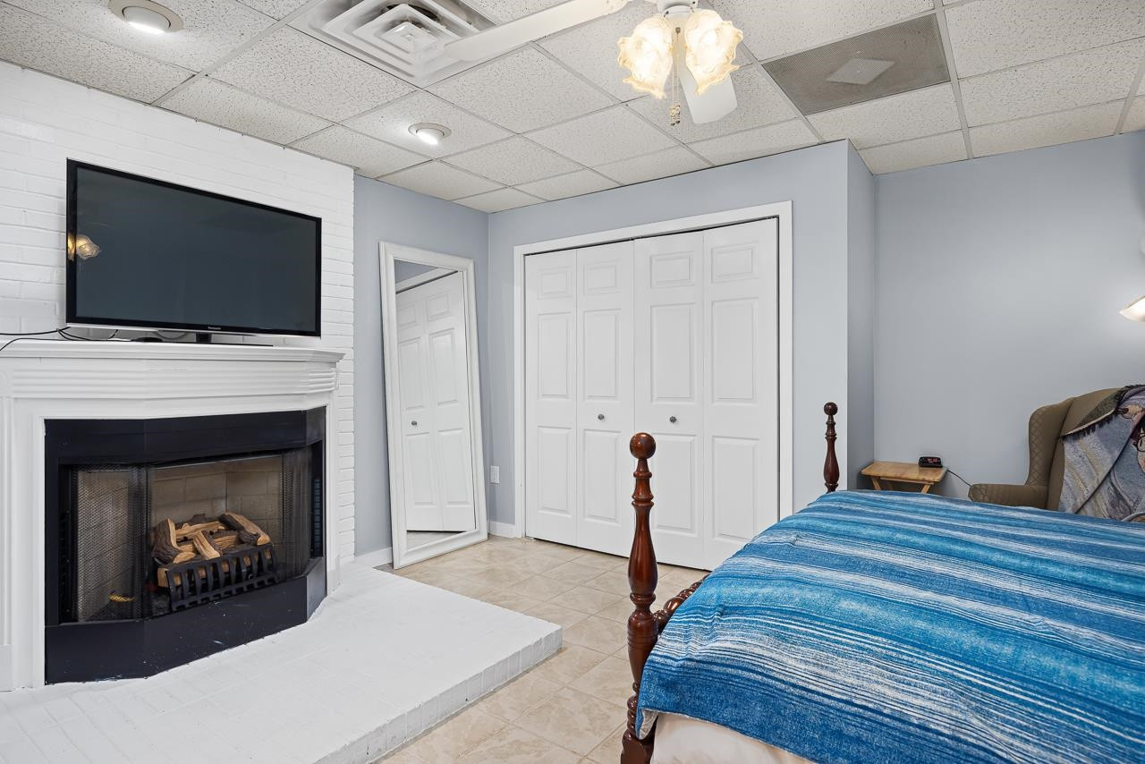 6345 Wynbrook Way Raleigh, NC 27612 - Photo 32 of 40 a living room with furniture a flat screen tv and a fireplace