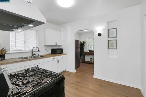 a kitchen with granite countertop a stove and a sink
