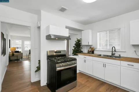 a kitchen with stainless steel appliances granite countertop a sink stove and cabinets