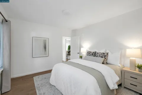 a bedroom with a bed and a night stand