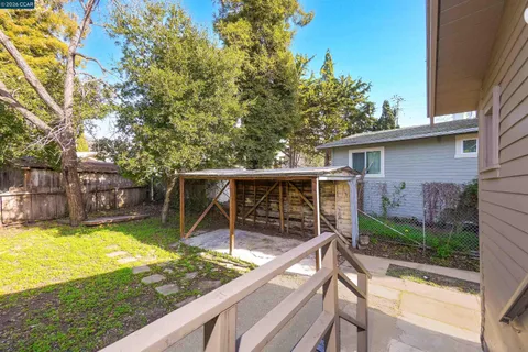 a view of a swimming pool with a patio and a yard