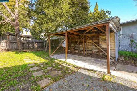 a view of a backyard with a table and chairs